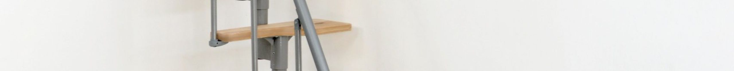 Vienna central stringer staircase with beech steps, grey metal railing, and PVC handrail.