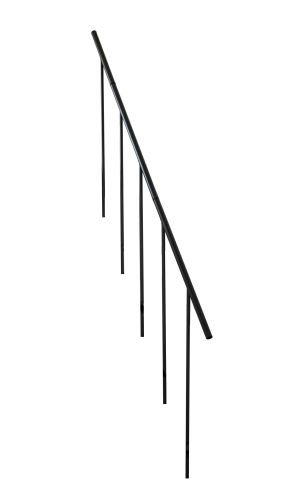 A toddler plays with colorful toys on the floor in front of the mounted "Annika" wooden child safety gate. The gate is installed between two walls, separating the play area from the kitchen behind.