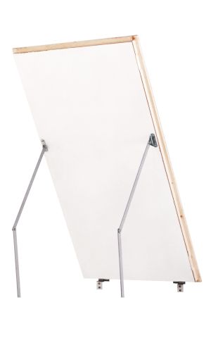 A toddler plays with colorful toys on the floor in front of the mounted "Annika" wooden child safety gate. The gate is installed between two walls, separating the play area from the kitchen behind.