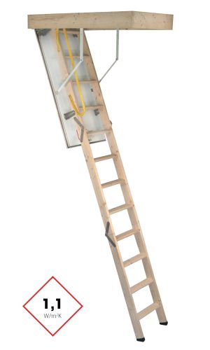 A toddler plays with colorful toys on the floor in front of the mounted "Annika" wooden child safety gate. The gate is installed between two walls, separating the play area from the kitchen behind.