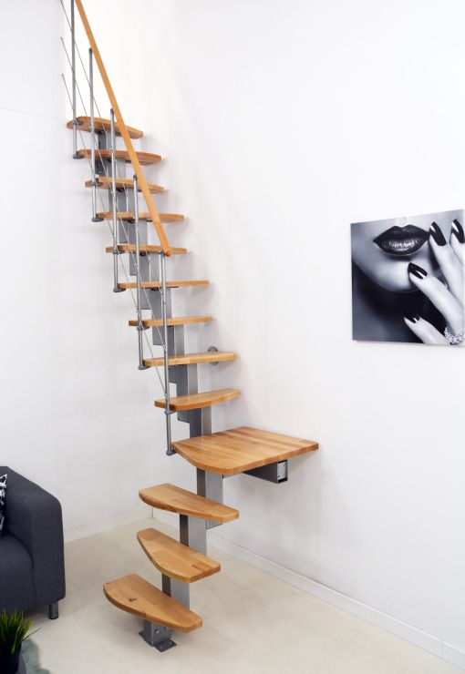 Quatro Turn central stringer staircase with quarter-turn winder steps made of beech, grey metal railing with horizontal bars, and a wooden handrail.