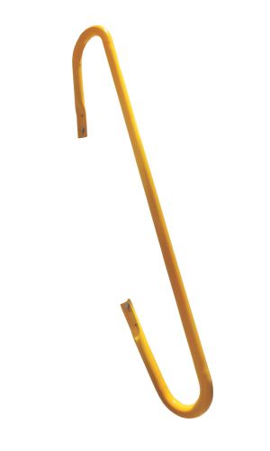 A toddler plays with colorful toys on the floor in front of the mounted "Annika" wooden child safety gate. The gate is installed between two walls, separating the play area from the kitchen behind.