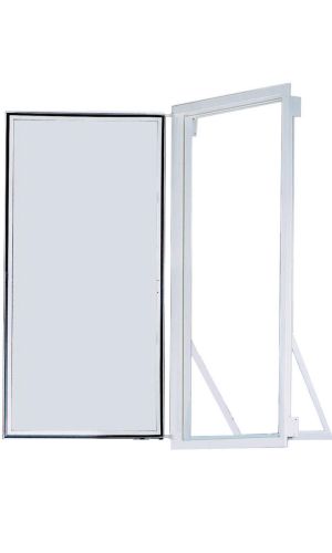 A toddler plays with colorful toys on the floor in front of the mounted "Annika" wooden child safety gate. The gate is installed between two walls, separating the play area from the kitchen behind.