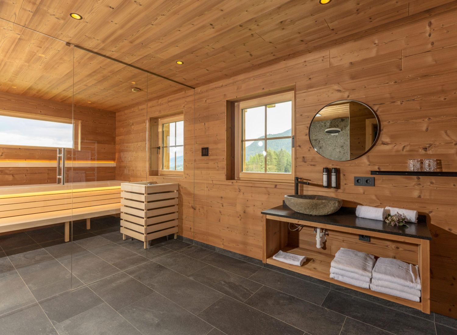 Wellness area with sauna in Almwelt Schwab-Walcher, featuring wall and ceiling cladding made of brushed Gladiola wood by Minka.
