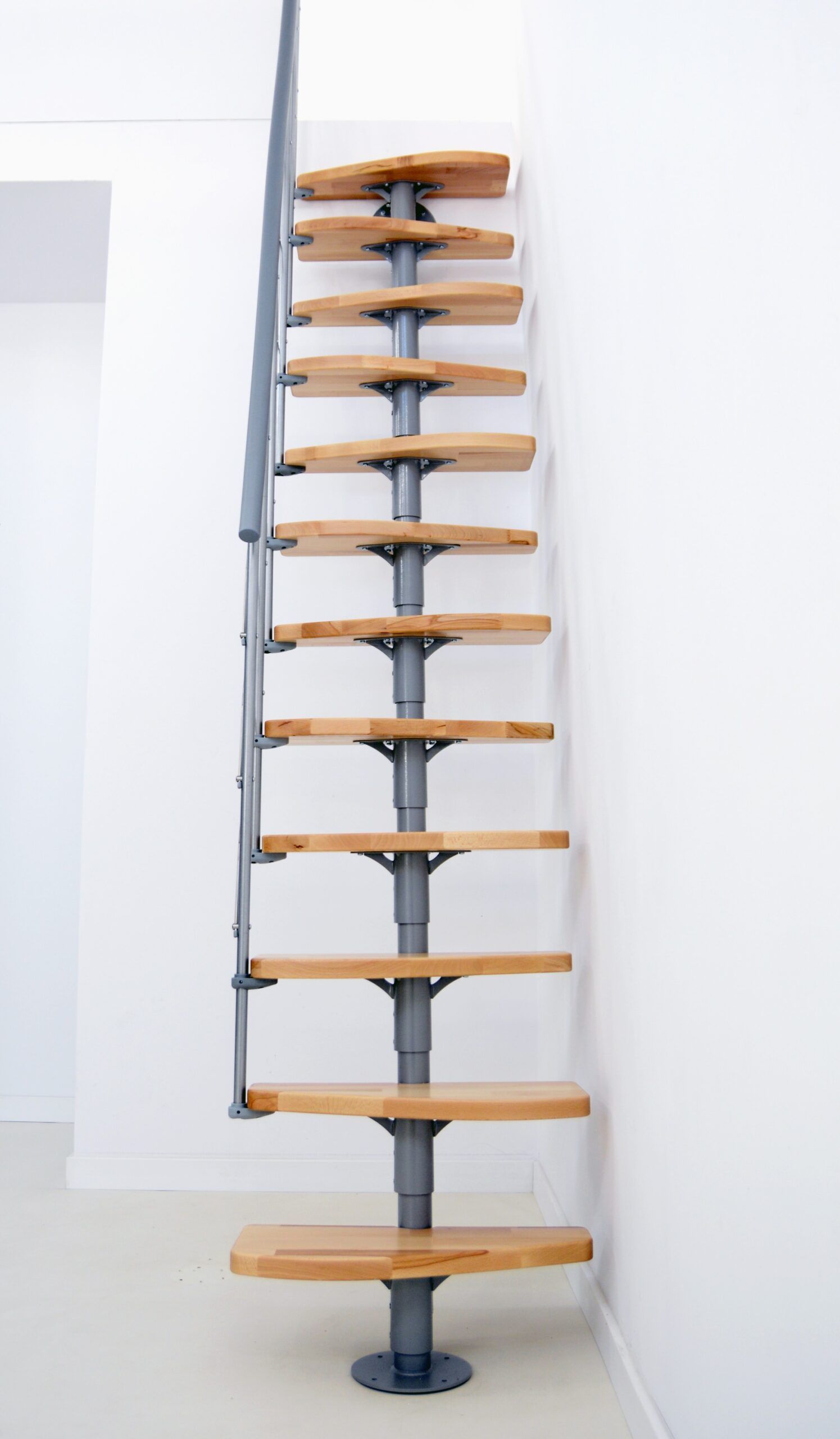 Space-saving staircase with alternating beech steps, grey metal structure, and a one-sided railing with horizontal bars and a grey handrail.