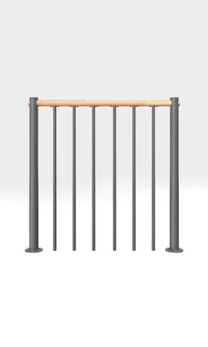 A toddler plays with colorful toys on the floor in front of the mounted "Annika" wooden child safety gate. The gate is installed between two walls, separating the play area from the kitchen behind.