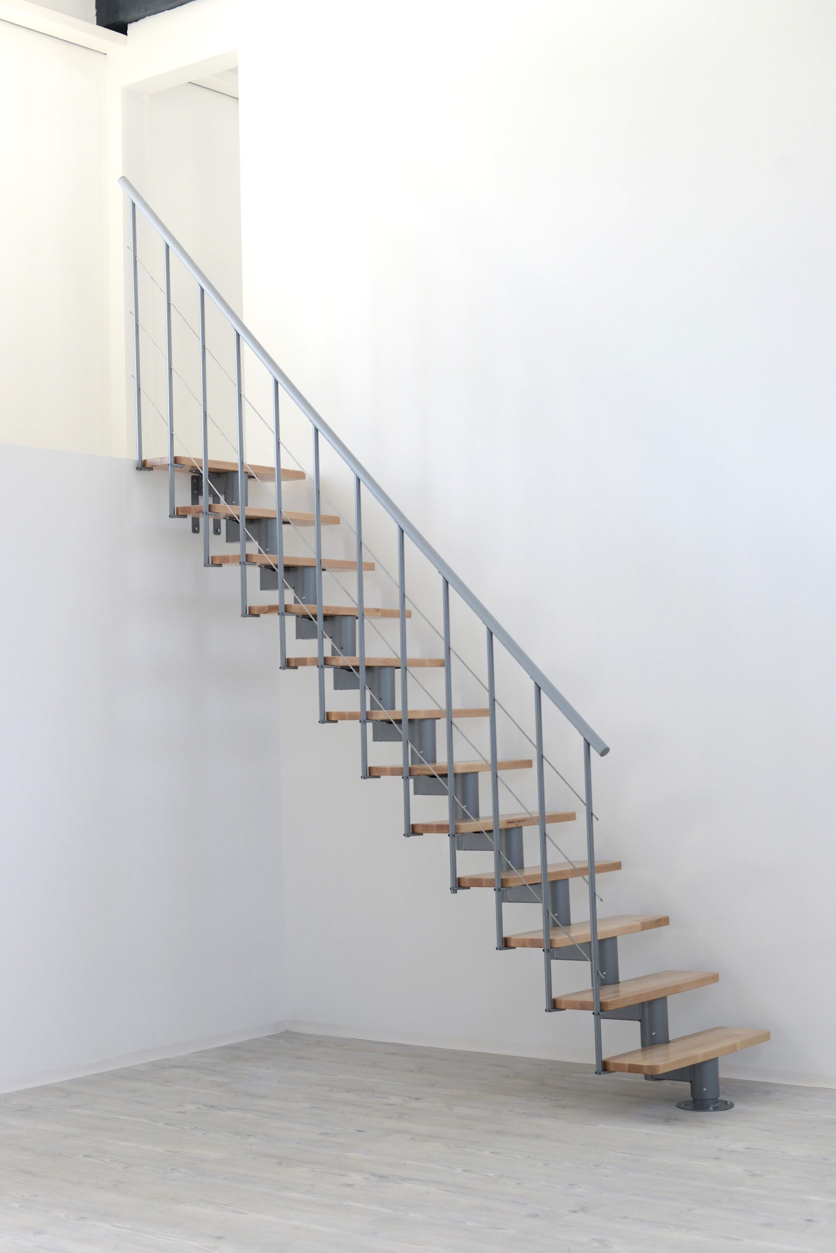Modern Comfort Top staircase with a gray metal central stringer construction and beech wood steps.