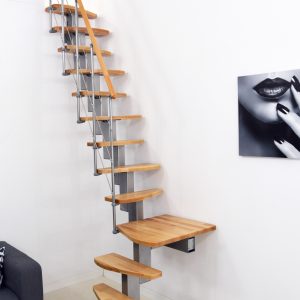 Quatro Turn central stringer staircase with quarter-turn winder steps made of beech, grey metal railing with horizontal bars, and a wooden handrail.
