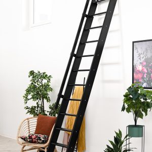 Black Flexiblo space-saving staircase made of wood with a straight, steep design and slim treads. The staircase is set up steeply against the wall.