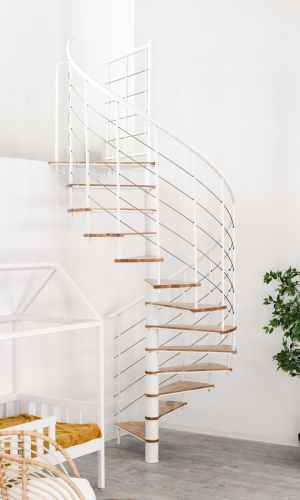Fusion spiral staircase with beech steps and white metal banister built into a bright room with plants, cot and chair.