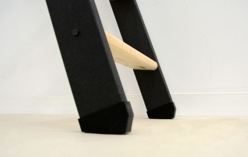 Detail view of the Strong space-saving staircase: Black plastic stair shoes at the lower ends of the stringers provide stability and a non-slip grip on the floor.