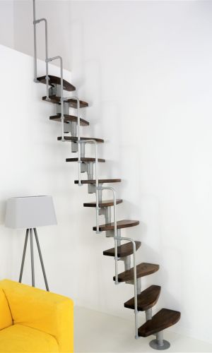 Monaco space-saving staircase with alternating walnut-finish steps and a grey metal structure. Equipped with a side metal railing that curves at the top end.