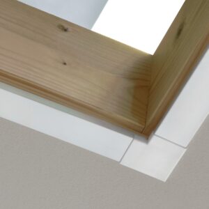 Nahaufnahme einer Holz-Zarge mit einer weißen Verkleidungsleiste vom Typ „Minka Fix“ mit 27 mm Breite, montiert an der Decke eines Innenraums.