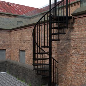 Außenspindeltreppe Rondo Zink Color in Schwarz vor einer Backsteinfassade. Die Treppe aus feuerverzinktem Stahl mit schwarzer Pulverbeschichtung verfügt über senkrechte Stäbe und Tränenblech-Stufen für sicheren Tritt im Außenbereich.